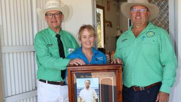 This Sir Donald Bradman signed bat sold for $14,000 in a special lot at last weeks Mordallup Angus bull sale at Boyanup to kick off the Nutrien Ag Solutions Bunbury teams Do it For Dolly Day 2024 fundraiser. With the bat were Nutrien Livestock auctioneer Tiny Holly (left), Nutrien Ag Solutions Bunbury Do it For Dolly Day co-ordinator Kate Demarti and Nutrien Livestock, Boyanup/Capel agent Chris Waddingham, Waddingham Rural Agencies, who donated the bat.