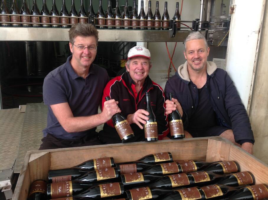 Michael Hutton, Morris Lay and Bradley Hutton bottling the new 2017 Coffee Fortified wine. Image supplied.
 