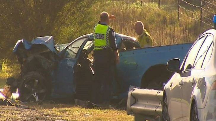 Police inspect the ute at the scene of the fatal crash. Photo: Nine News