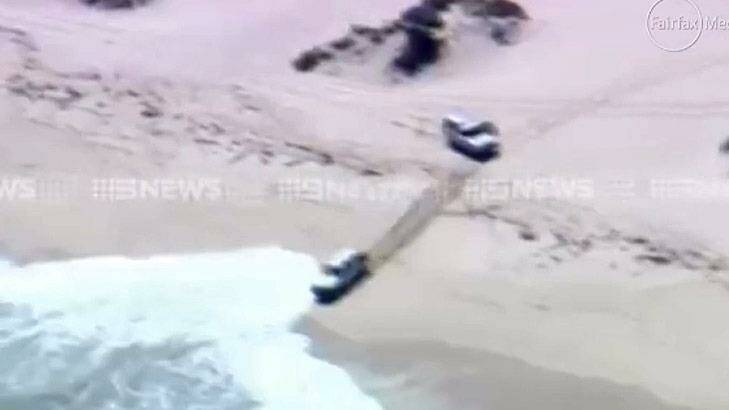 The Toyota straight into the waves, forcing the the offenders to climb out of the window.  Photo: 9 News Perth
