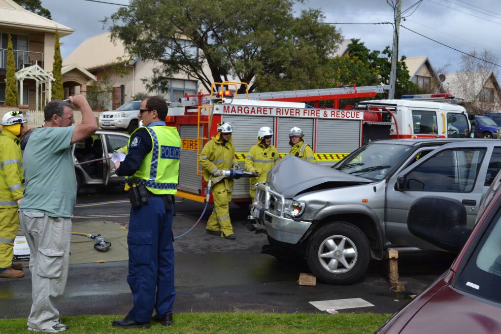 Drastic: Margaret River Fire and Rescue crews prepare to cut the door to release a trapped woman.