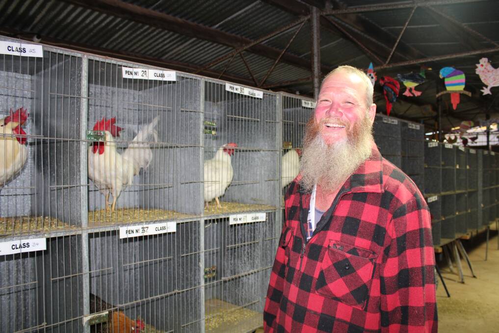 Beautiful birds: Two Oceans Poultry Club vice president Les Oxley explains the different types of birds at the Poultry Show.
