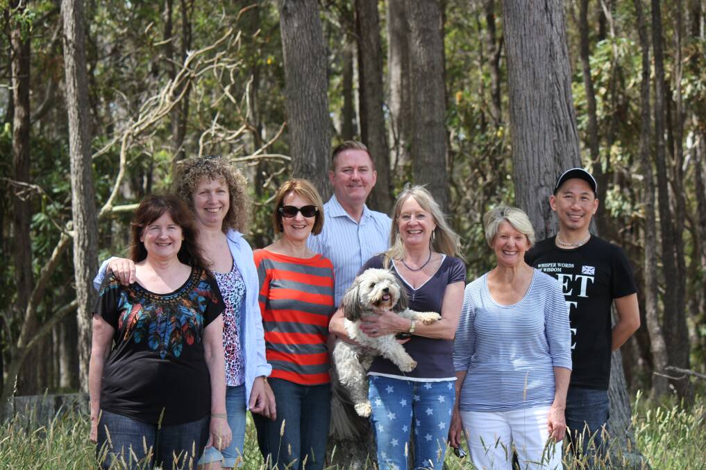 Community spirit: Olivia Lancaster, Jane McMillian, Di Gordon, Clinton Truman, Vicki Genge, Bev Evans and Andy Lau do their bit in the Brookfield Forest clean-up.