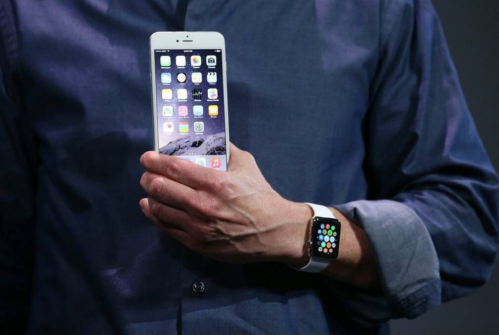 Apple CEO Tim Cook shows off the new iPhone 6 and the Apple Watch.