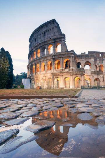 Landmark: The Colosseum in Rome at sunrise.