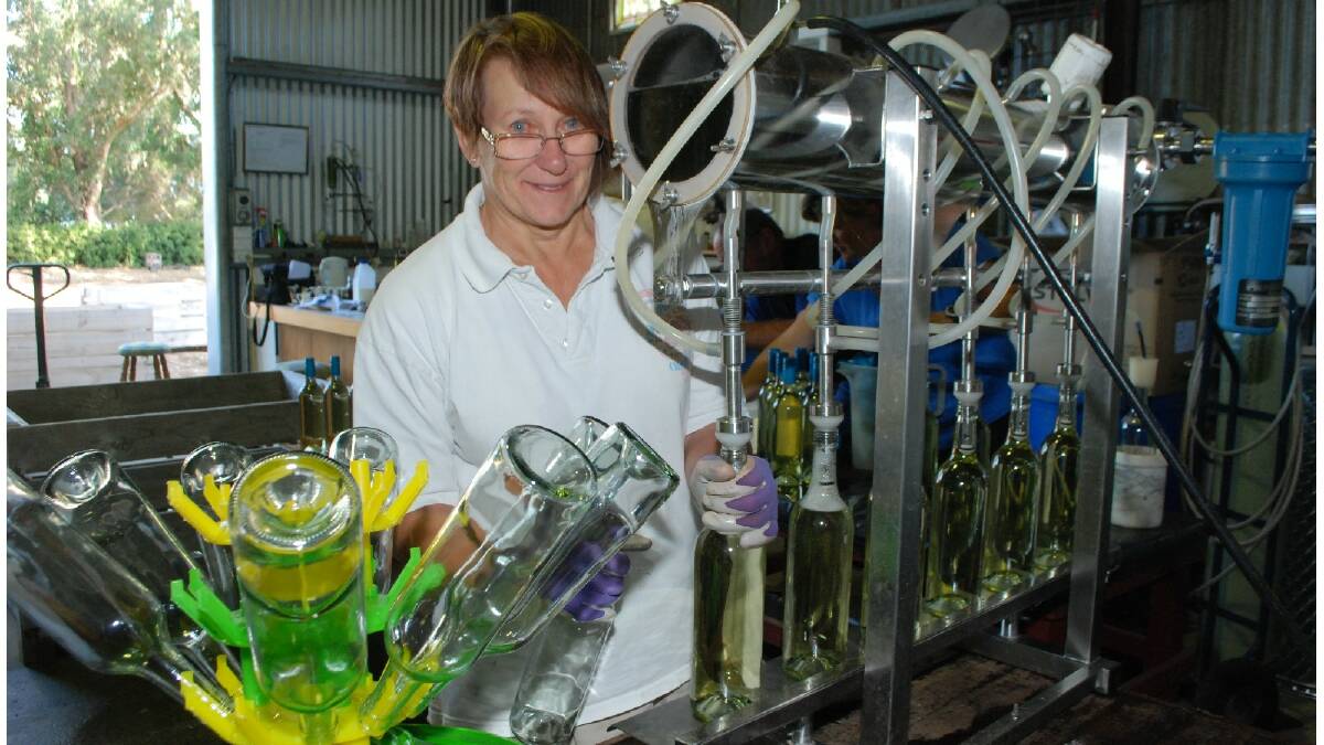 Hard at work: Dalyup River Wines member Louise Gray helps out during the bottling of the winery's final batch of whites. Photo: Esperance Express.