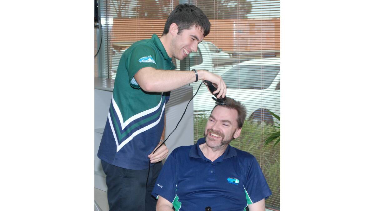 Going, going, gone: Shire of Esperance chief executive officer Matthew Scott has his head shaved by Shire staff member Joel Wickstein to raise money for Movember. Photo: Esperance Express.
