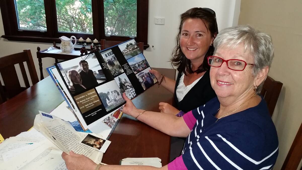 Margaret River resident June Page and Marcus' daughter Raphaelia looking at letters and photos the pair swapped over the years. 