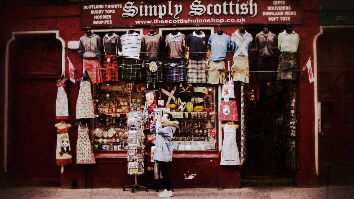A woman stops to take a photograph outside a shop on the Royal Mile on April 23, 2014 in Edinburgh, Scotland. Pic: Jeff J Mitchell/Getty Images
