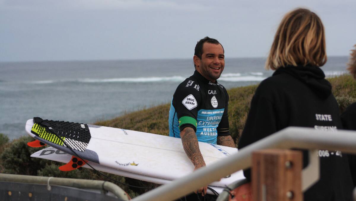 Pro surfer Raoni Monteiro, ranked 24th in the WCT, exits the water after his Round 1 heat. Photos by Zannia Yakas