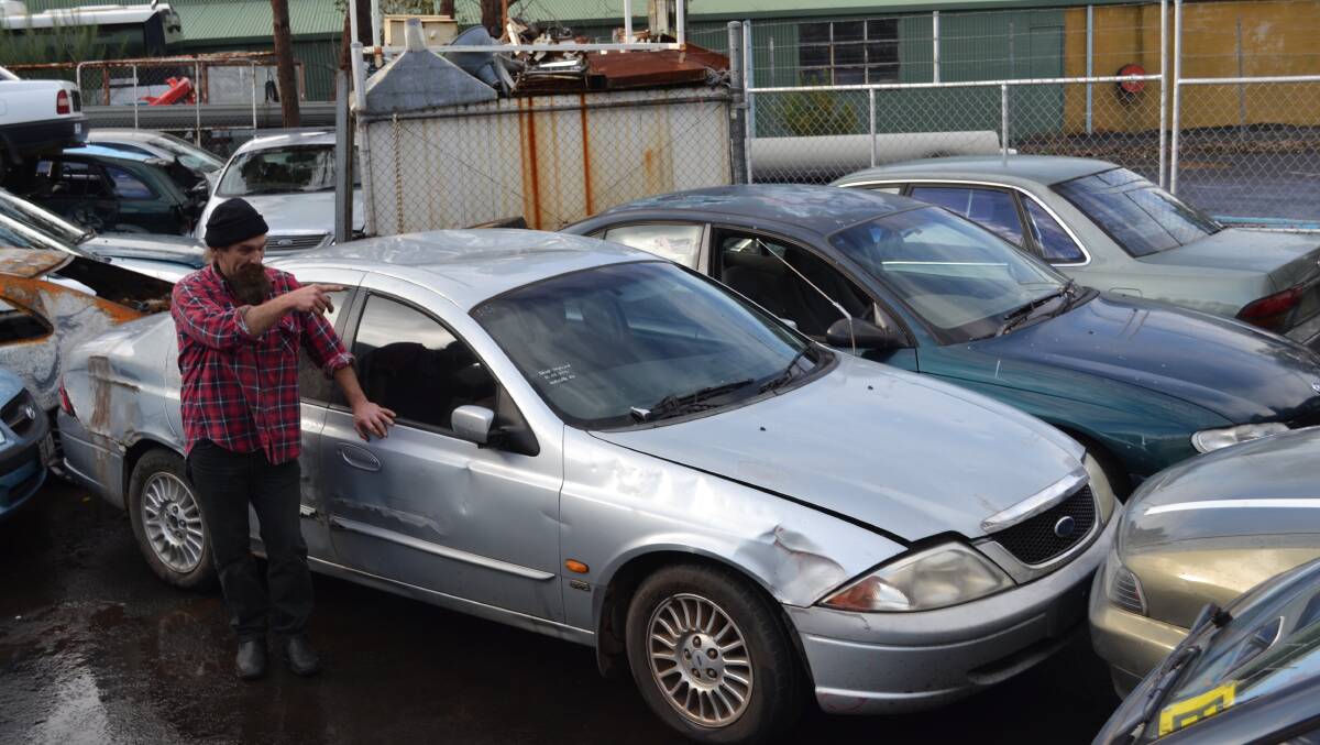 Margaret River Towing's Gordon Johnston gestures to four abandoned cars he's recently retrieved from the local area.