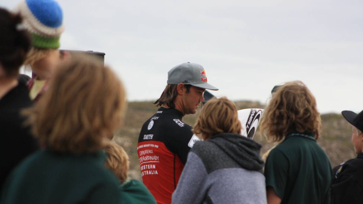 South Aftrica's Jordy Smith, ranked 4th on the WCT, stops to sign a few things for local children.