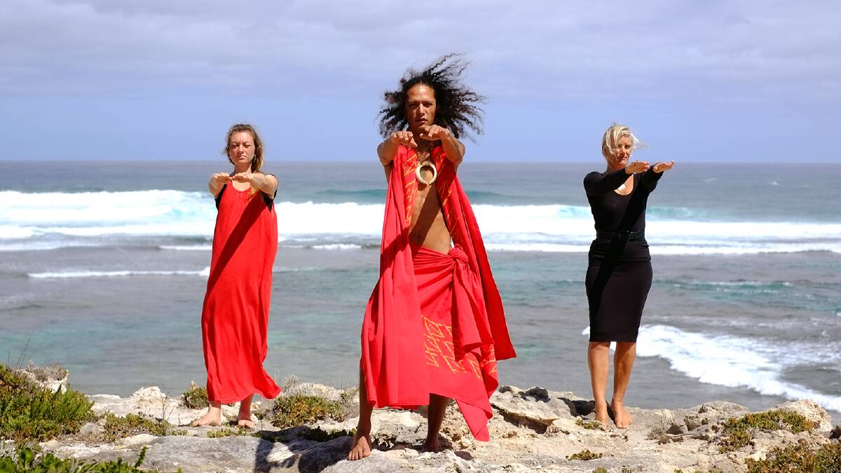 Kawika Foster leads Jessica Woodrow and Kathryn Roberts in a traditional Hawaiian hula dance ahead of this weekend's workshops. Photo by Sandy Powell. 