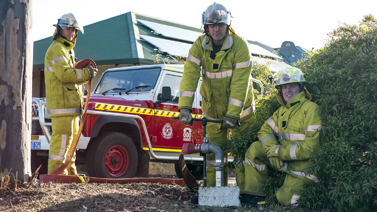 Margaret River Volunteer Fire and Rescue service volunteers Joel Busby and Darrell Morrison with Captain Jeff Bushby uncovering one of the town’s recently covered fire hydrants. Photo by Sandy Powell. 