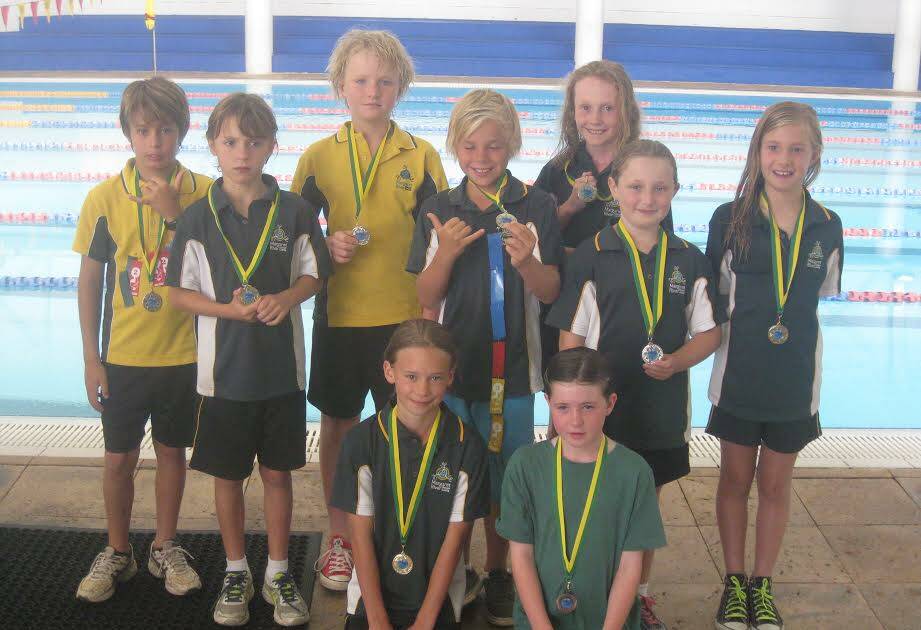 Award winners: Danny Benedetti, George Wolsley, Felix Rice, Austin Dempsey, Tara Anderson, Leona Humphreys, Ava Robins with Ruby Pedrick and Patricia Kelly celebrate a great day of swimming.