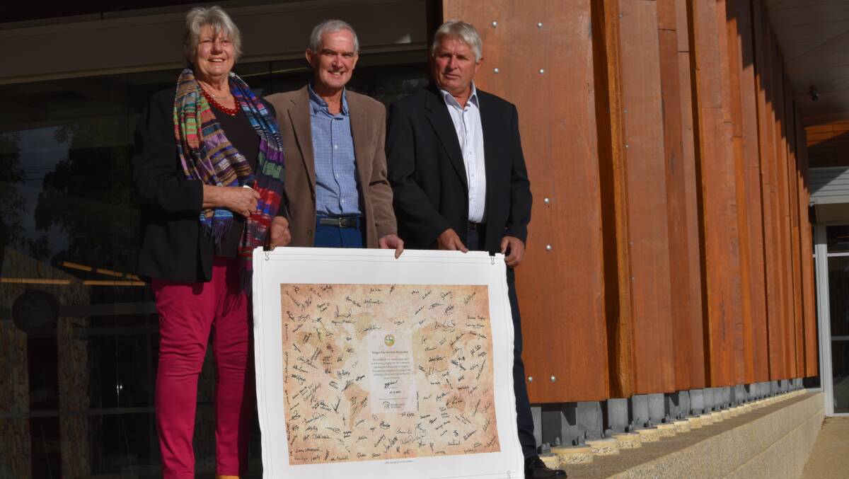 Councillors Felicity Haynes, Michael Smart and Ian Earl joined together to show their support of the council's decision, signing the refugee welcome banner.