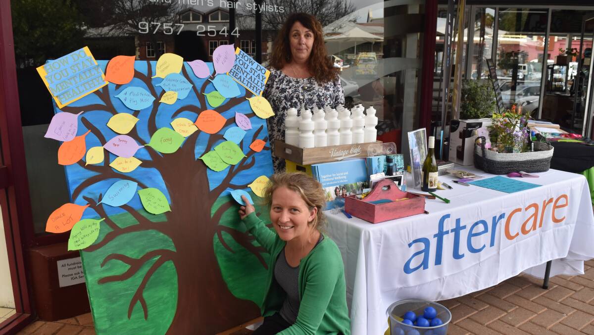 Awareness: Aftercare care coordinator Lucy Akerman and Life Without Barriers care coordinator Kerrie Stephens joined forces to spread the mental health awareness message through a stall outside of IGA on Saturday morning, creating an ideas tree of how people stay happy.