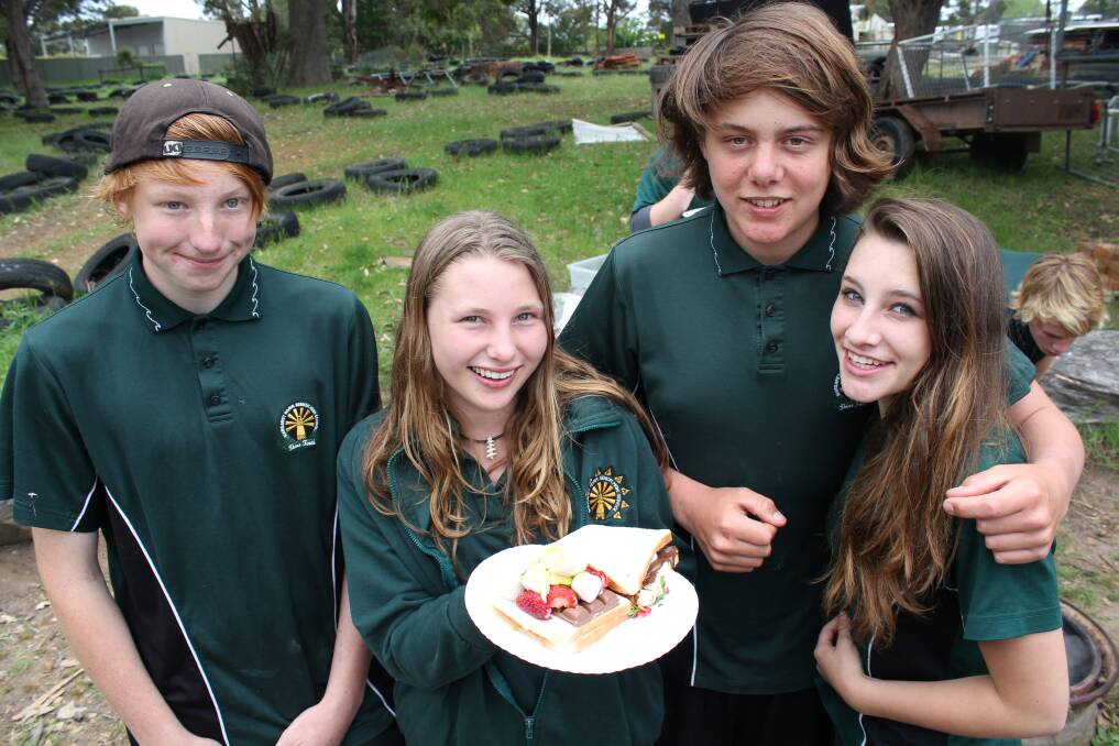 Year 10 students Zac Waterhouse, Louise Dumpleton, Darcy Rochford and Kiera Haworth practise outdoor survival skills, learning to make fire, gather wood and cook tasty jaffas.