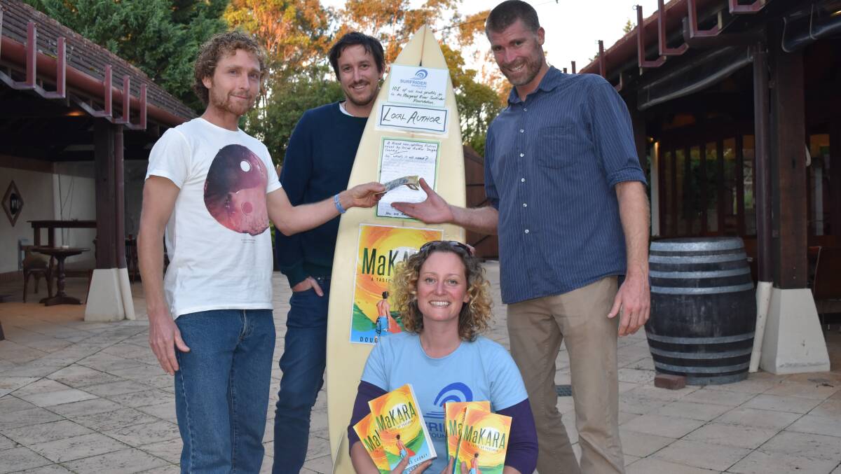 Novel support: Surfriders Drew Mckenzie, Adrian Meder and Laura Bailey celebrate the donation from author Douglas Cooney.