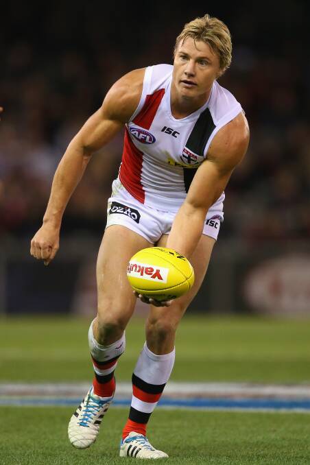 Clinton Jones of the Saints handballs during the round five AFL match between the Essendon Bombers and the St Kilda Saints at Etihad Stadium on April 19, 2014 in Melbourne, Australia. Photo: Quinn Rooney/Getty Images.