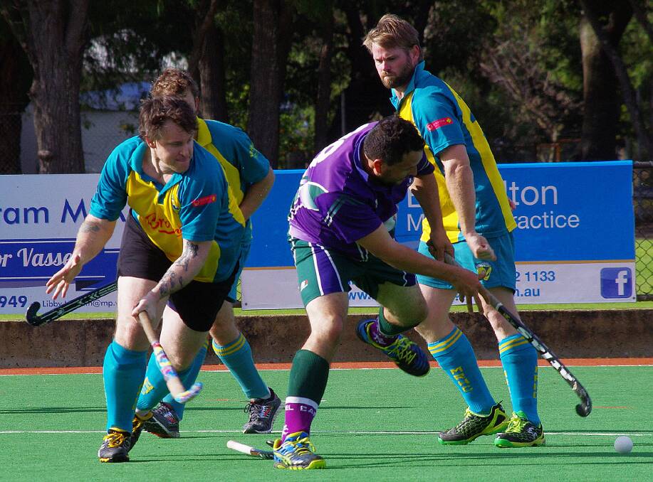 Pressure cooker: After a strong tackle from Gartrell (who lost his stick), Brendan Slaven closes in on the Capel player. Photo: MR Hockey