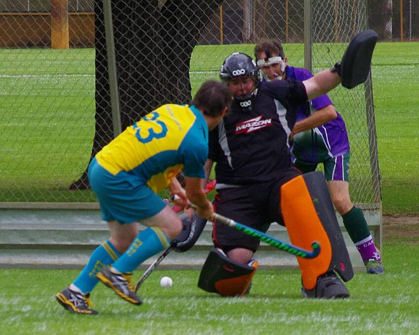 Finesse: Luke Altmann skilfully pushes the ball past the Capel goalkeeper and fullback to bring up a goal. Photo: Margaret River Hockey Club