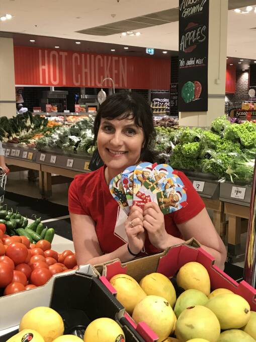 Christmas Cheer: Redkite’s Isobel Lindley with the donation cards available at Coles Margaret River. Photo: Supplied.