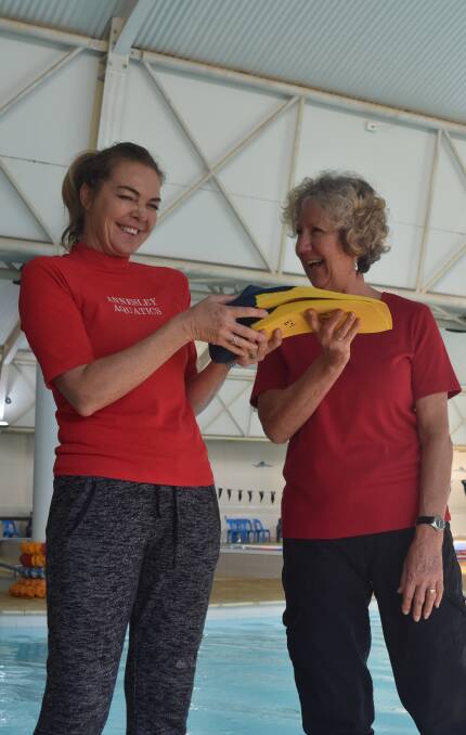 Passing the torch: Bev Annesley (right) hands over the flippers to long time colleague and new school owner, Roberta Williams. Photo: Nicky Lefebvre
