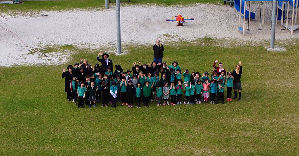 Remote control: Augusta Primary School students and teachers enthralled by the UAV drone as it captures this image. Photo: UAV Resources.