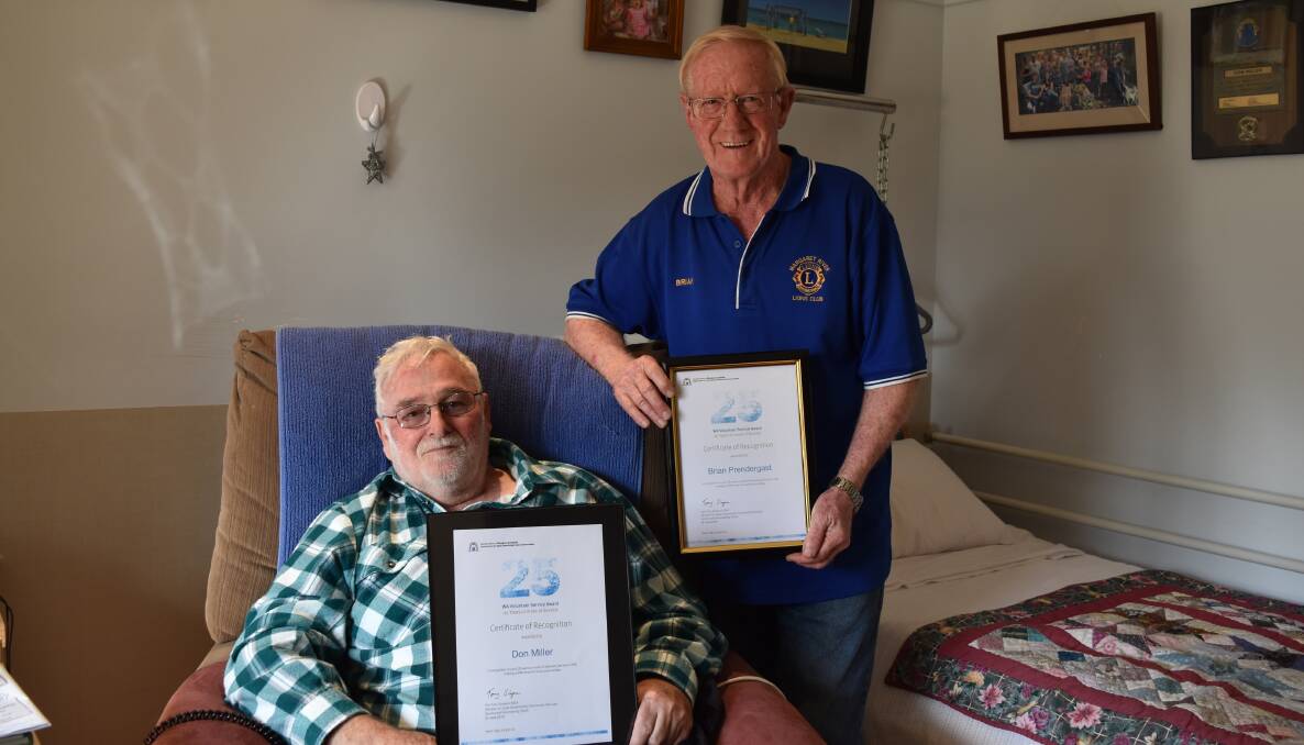 Decades of help: Don Miller and Brian Prendergast with the certificates recognising their years of service to the community with the Lions Club. Photo: Nicky Lefebvre