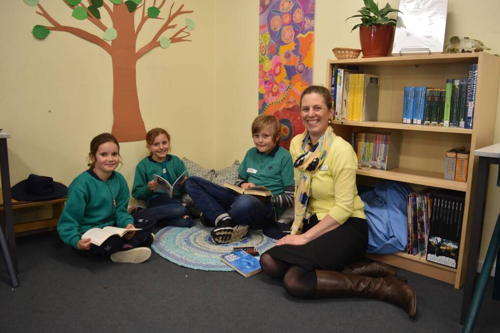 Deni Smyth, Tani Gilboa and Jack Holzer join principal Lisa Fenton for some reading time at the Montessori School. 