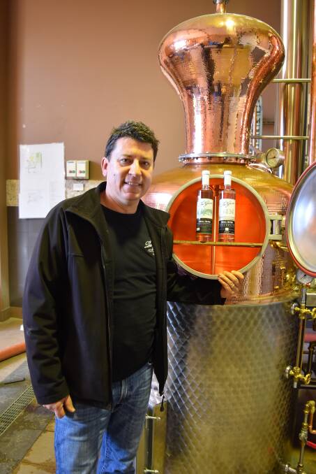 High spirits: James Reed with The Grove's new still and two of his award-winning spirits, Caribbean Spiced Rum and Absinthe. Photo: Nicky Lefebvre