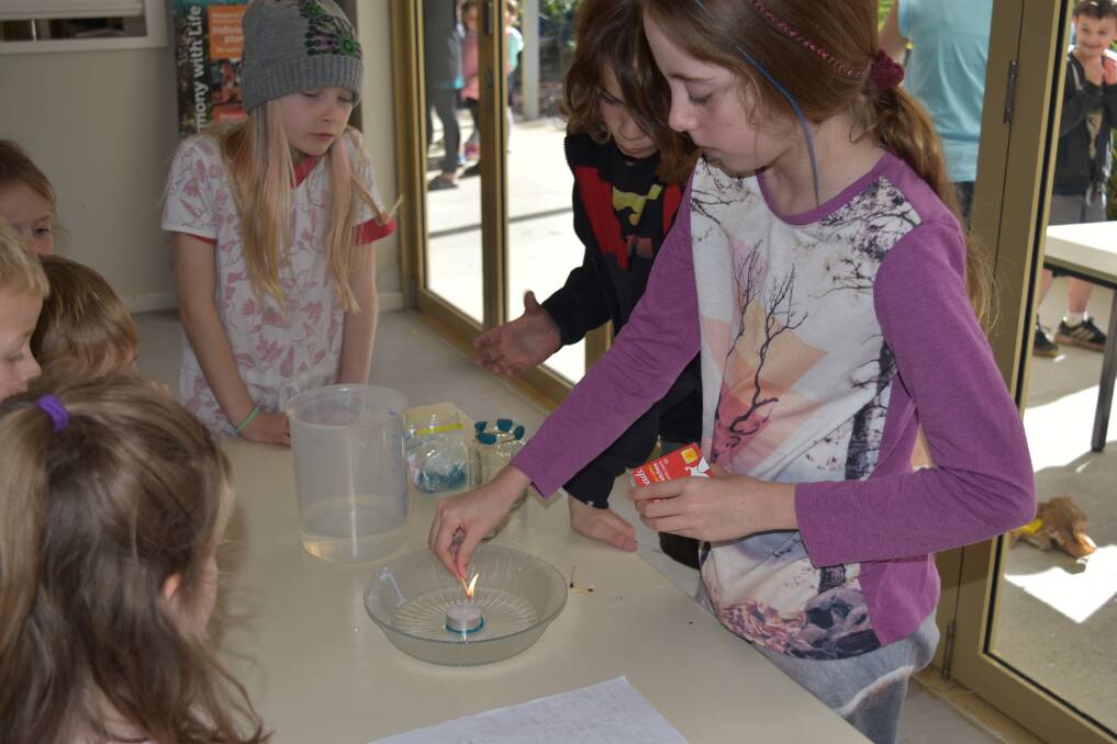 The expo-style science fair had groups of students moving between stands scattered around the school campus. 