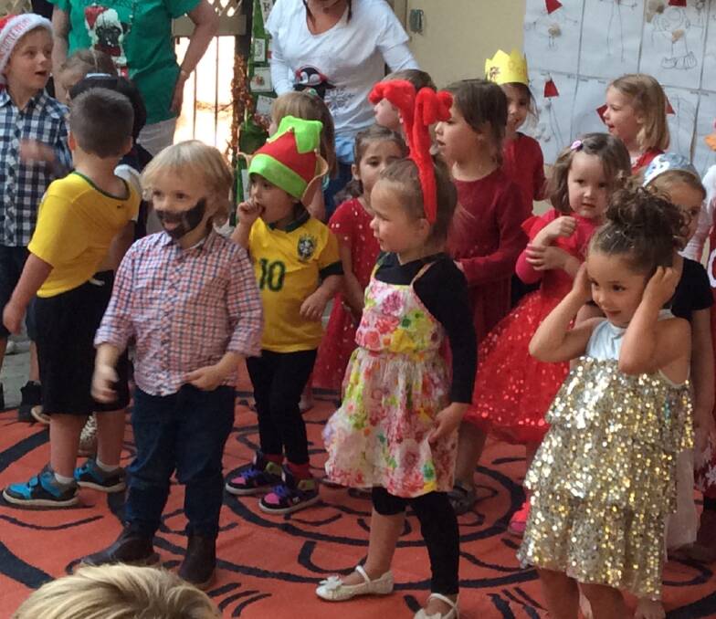 Excited: The littlest members of the performing group come to grips with the choreography, costumes and songs at their Christmas concert. Photos: MRCRC