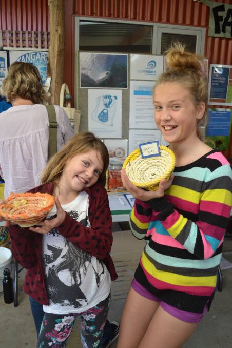 Clever idea: Makaylah and Lily Olthof present the recycled rope baskets they found at the Tangaroa Blue stall.
