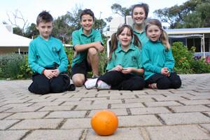 FORBIDDEN FRUIT: Augusta students Oliver Clarke, year 3, Lachlan Rees, year 6, Abbey Galvin, year 2, Megan Head, year 7, and Lucy Clarke, year 1, resist an orange in preparation for the 40 Hour Famine.