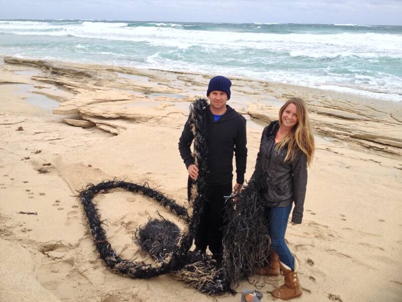 Locals lend a hand: Siblings Patrick and Heidi Becker look forward to the WA Beach Clean Up weekend. They pitched in to remove this plastic rope during a walk along Gas Beach, Margaret River recently.