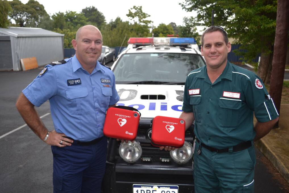 Lifesavers: Community paramedic Dane Hendry and sergeant Paul Daly with the new heart-starters for the police vehicles.