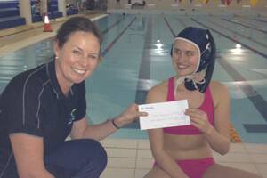 GOOD LUCK: Roz Cummings from Down South Camping & Outdoors presents Sunny Pasco with a cheque to help her and three other Margaret River underwater hockey players get to the Gold Coast to represent Australia at the Southern Hemisphere Underwater Hockey Championships.