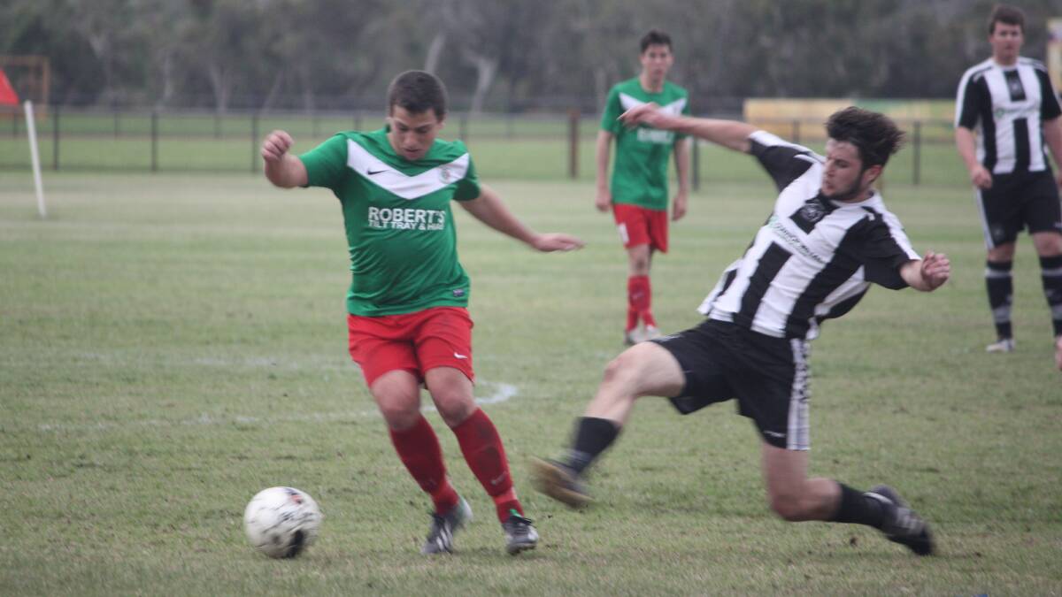 A Hay Park defender dives in to tackle Graeme Millington from Bunbury United.