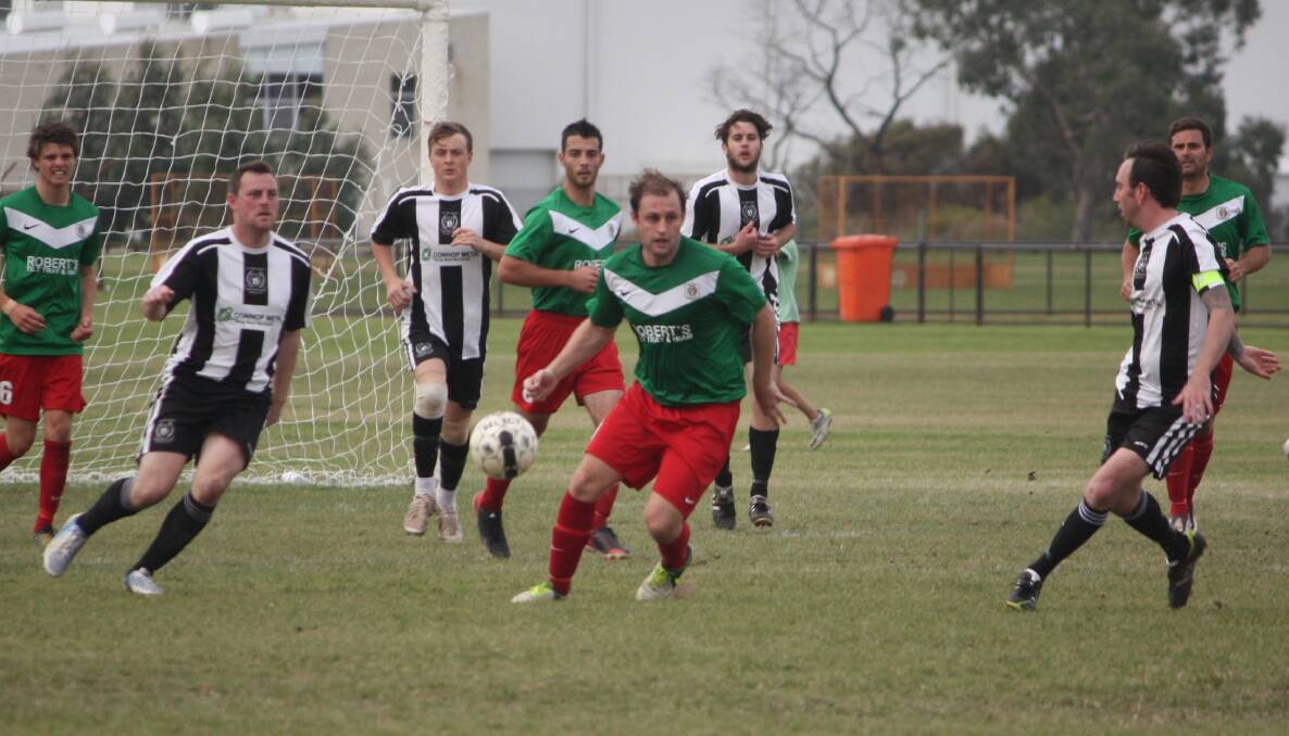 Bunbury United's Aaron Brittan, centre, in action against Hay Park at the Soccerdrome.