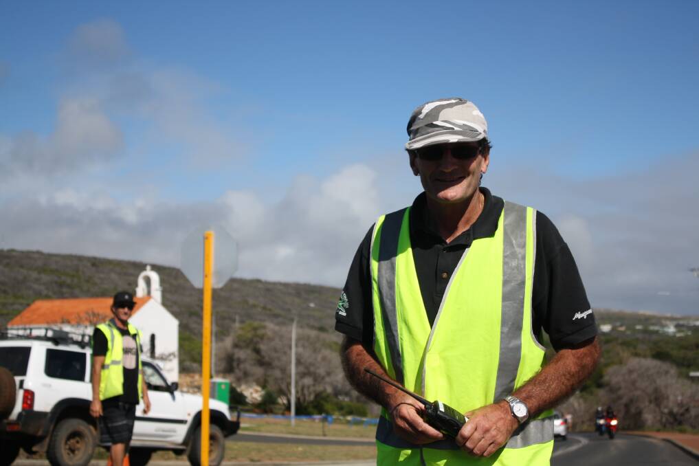 Locals help out: Fred Yates of the Augusta-Margaret River Hawks footy club has a tough job directing traffic in the hot sun.
