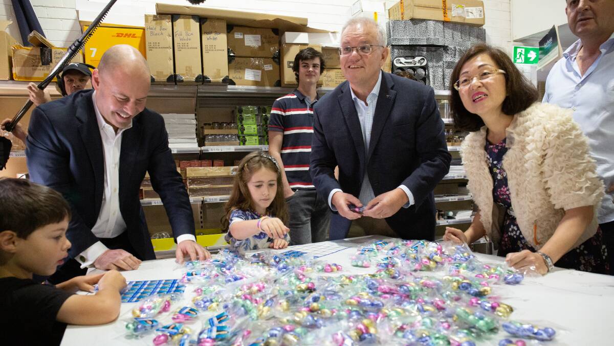 Treasurer Josh Frydenberg with his children Blake and Gemma, Prime Minister Scott Morrison and Gladys Liu visit Wallies Lollies in Box Hill South in the electorate of Chisolm, east Melbourne on Saturday. Picture: James Croucher