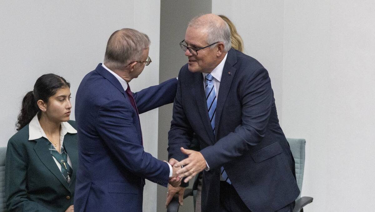 Prime Minister Anthony Albanese shakes hands with former prime minister Scott Morrison. Picture by Gary Ramage