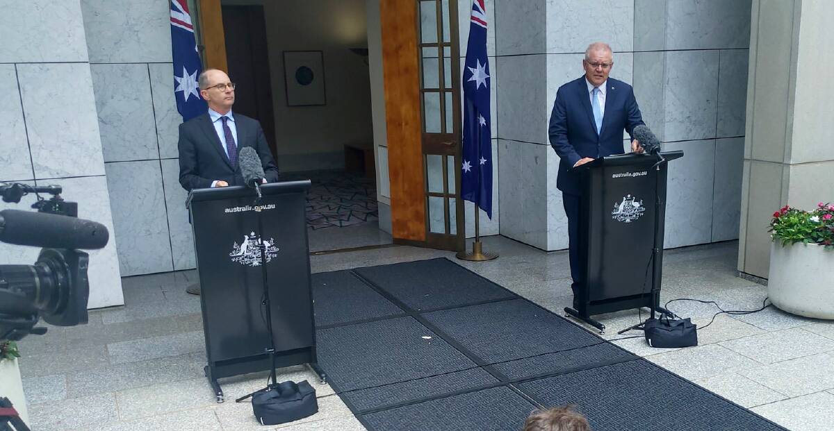 Chief medical officer Paul Kelly, left, and Prime Minister Scott Morrison announce the changes on Friday. Picture: Katie Burgess