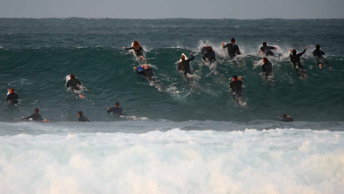 Surfers take advantage of the monster swell across the Illawarra on Saturday. Photo: Sylvia Liber