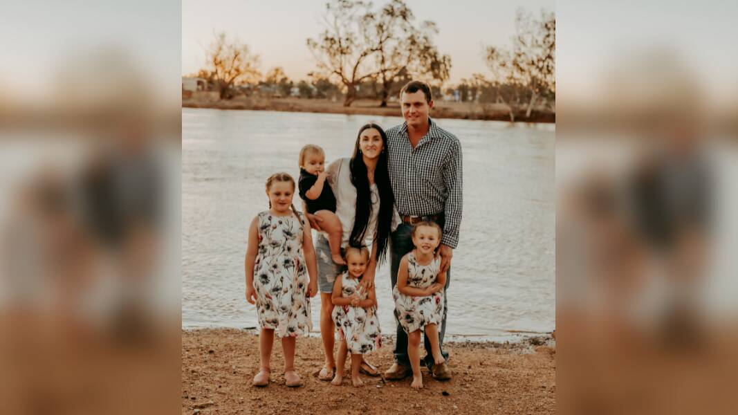 Maryellen Boyd Blacket and husband Scott Blacket with their children Maryjane, 7, Boyd, 1, Violet, 2, and Dakota, 5, on the banks of the Burke River, where Boulia Caravan Park is situated. Photo: AliB Photography
