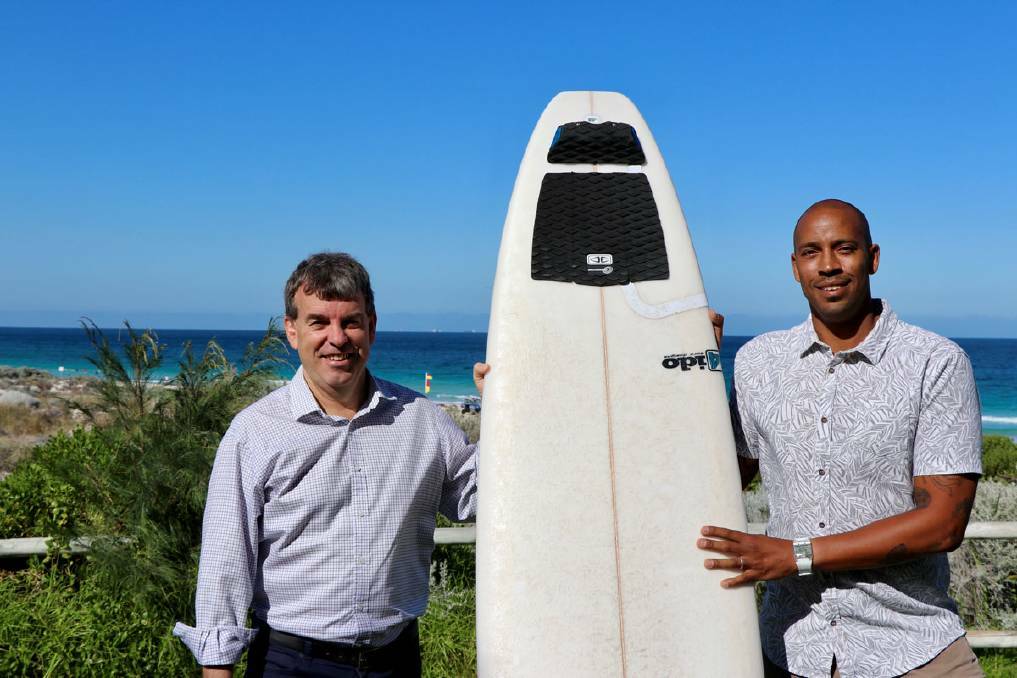 Fisheries minister Dave Kelly with Justin Majeks from Surfing WA and a surfboard with the Ocean Guardian FREEDOM+ SURF device attached.