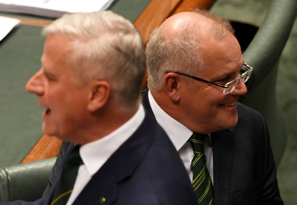 Double dippers: Deputy Prime Minister Michael McCormack and Prime Minister Scott Morrison in parliament on Monday when they both paid tribute to Tim Fischer.