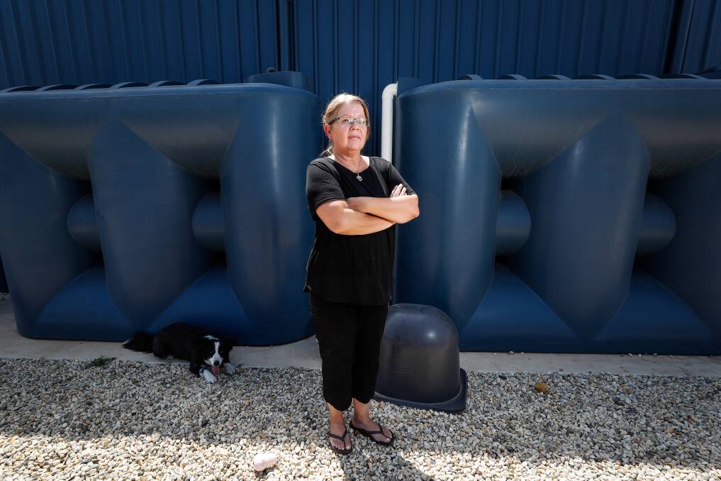Stunned: Chiltern resident Carol Ziebarth with her two 5000-litre water tanks which were found empty on Monday. Picture: JAMES WILTSHIRE